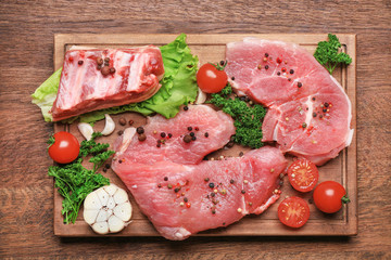 Wooden board with different types of meat on table