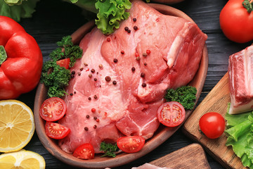 Plate with fresh raw meat on table