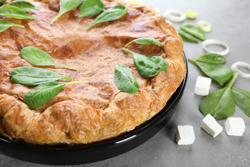 Tasty pie with spinach on table