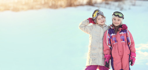 Fototapeta na wymiar Young happy girls have fun on a winter sunny day