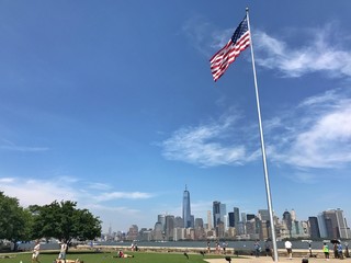 USA Flag in New York City on Ellis Island with View of Downtown Manhattan in the Background