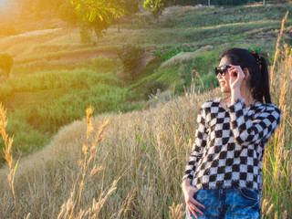 woman posing and touch sunglasses on nature background