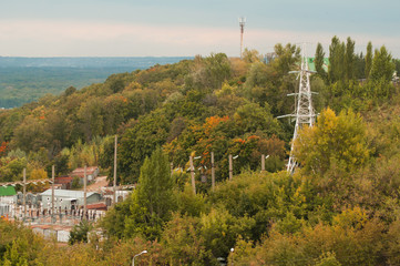 Obraz premium High-voltage power transmission towers among the trees,