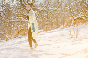 Cute fashion Girl barefoot on white cold snow in winter. Quenching tempering harding health...