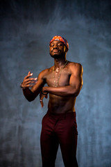 
African American dancing breakdance at a health sports center. Man teaches fitness exercises in the gym