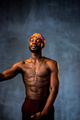 
African American dancing breakdance at a health sports center. Man teaches fitness exercises in the gym