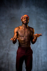 
African American dancing breakdance at a health sports center. Man teaches fitness exercises in the gym