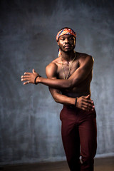 
African American dancing breakdance at a health sports center. Man teaches fitness exercises in the gym