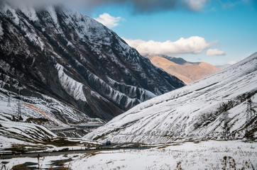 Georgian military road. The scenic winding road among the snowy mountains in Georgia. Main Caucasian Ridge and Cross Pass Gudauri in winter.