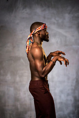 
African American dancing breakdance at a health sports center. Man teaches fitness exercises in the gym