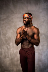 
African American dancing breakdance at a health sports center. Man teaches fitness exercises in the gym