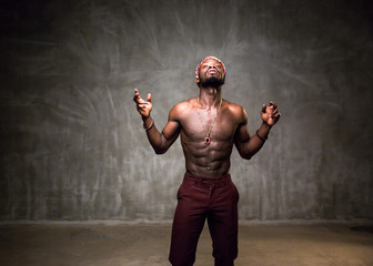 
African American dancing breakdance at a health sports center. Man teaches fitness exercises in the gym