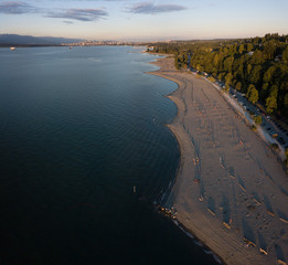 Aerial panoramic view of the beautiful beach, Spanish Banks, during a vibrant summer sunset. Taken in Vancouver, British Columbia, Canada.
