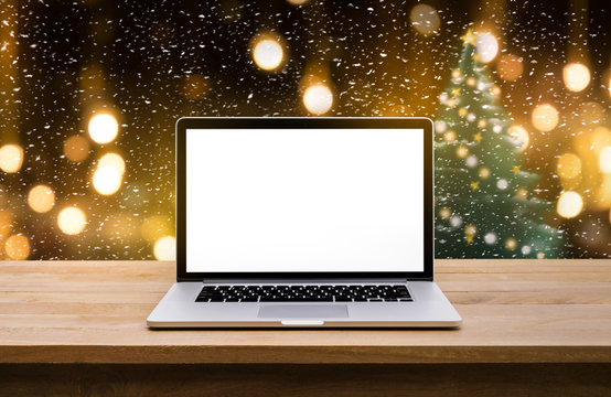 Computer,laptop with blank screen on  snowfall in night.christmas winter backgrounds ideas