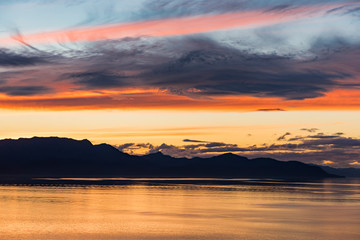 Fototapeta na wymiar Alaskan coastline sunset with mountain silhouette