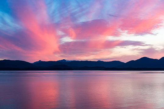 Alaskan coastline sunset with mountain silhouette