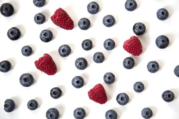 Blueberries and Raspberries Scattered Isolated on White Background Abstract Pattern Top View
