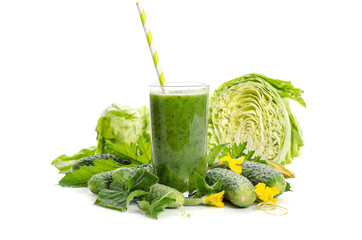  glass with green smoothie  and  vegetables, leaves, flowers  isolated on white background