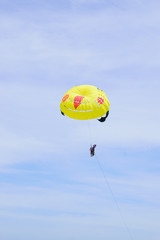 Yellow parachutes in the sky float over the Andaman Sea.