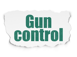 Protection concept: Gun Control on Torn Paper background
