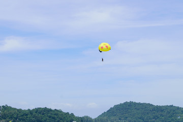 Yellow parachutes in the sky float over the Andaman Sea.