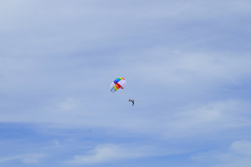 Naklejka na ściany i meble The sky parachute has a blue backdrop background.