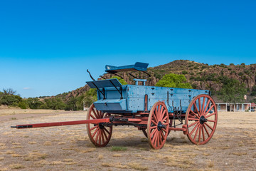Fototapeta na wymiar Close up view of old blue chuck wagon with red wheels