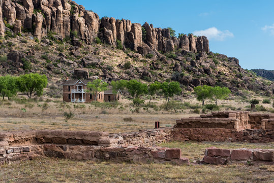 Ruins of fort buildings in the foreground with officer quarters in the background on Fort Davis
