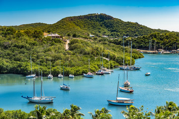 Tropical bay on Antigua with small boats - obrazy, fototapety, plakaty