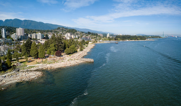 Aerial panoramic view of luxury homes on the ocean shore during a vibrant sunny summer day. Taken in West Vancouver, British Columbia, Canada.
