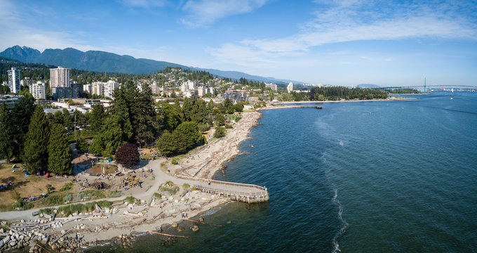 Aerial panoramic view of luxury homes on the ocean shore during a vibrant sunny summer day. Taken in West Vancouver, British Columbia, Canada.

