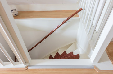 White wooden stairs with red mats