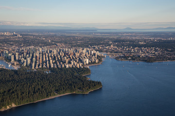 Naklejka premium Aerial view from an airplane of Downtown City during a summer sunset. Taken in Vancouver, British Columbia, Canada. 