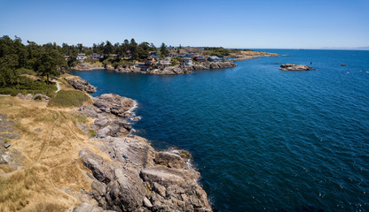 Aerial panoramic landscape view of a beautiful rocky shore on Pacific Coast. Taken in Saxe Point Park, Victoria, Vancouver Island, British Columbia, Canada.