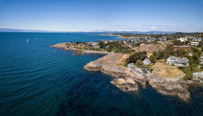 Fototapeta na wymiar Aerial panoramic landscape view of a beautiful rocky shore on Pacific Coast. Taken in Victoria, Vancouver Island, British Columbia, Canada.