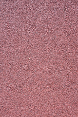 Small gravel, colored asphalt background closeup photo