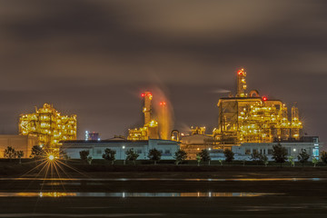 Fototapeta na wymiar scenic of petrochemical oil refinery plant shines at night, closeup