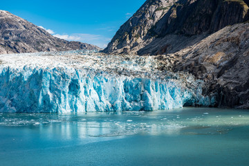 Wide angle view of glacier face with blue ice