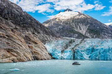 Fototapeta na wymiar Wide angle view of Alaskan glacier with small tourist boat