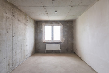 Room in new building without repair, partially plastered walls