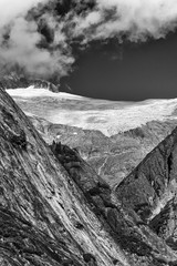 Monochrome view of alaskan mountain top with crossing valley