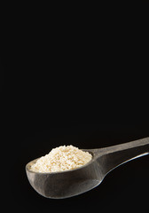 Seeds of sesame on wooden spoon - Sesamum indicum