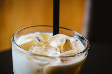 Glass of iced coffee or latte on a wooden table