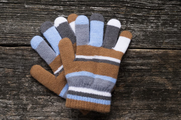 colorful gloves on wood background