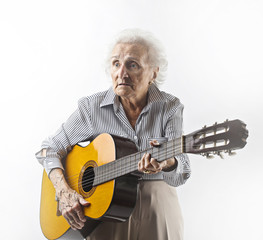 Elderly lady playing guitar