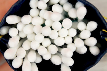 Close up of Cotton Buds. Texture of cotton wool close-up. Clearly, each thread is clearly visible. Wands look after flowers. The concept of optical illusion