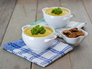 Traditional pumpkin soup on a wooden table. 