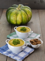Traditional pumpkin soup on a wooden table. 