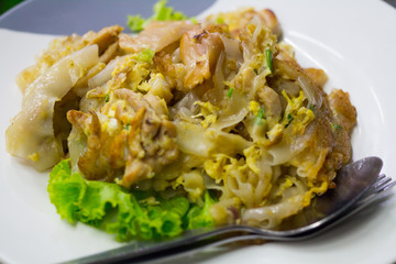 Stir fried flat noodle and chicken and egg Thai street food