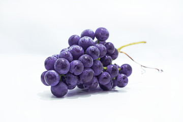 Raw dark grapes isolated on white background.